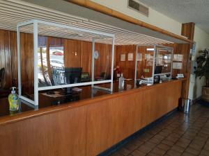 a waiting room with a counter in at Hotel Las Palmas Midway Inn in Matehuala