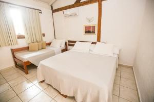 Cama ou camas em um quarto em Pousada Tambayba