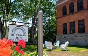 a sign for the sherman inn in front of a building at Sherman Inn in Ogdensburg
