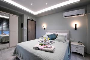 A bed or beds in a room at Adell Deluxe Apartments