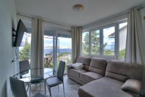 a living room with a couch and a glass table at Nehaj in Senj