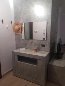 a bathroom with a sink and a mirror at Santa Maura in Vico Equense
