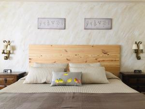 a bedroom with a large bed with two pillows at Hotel Barbacedo in Mijares