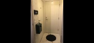 a bathroom with a toilet with a door and a mirror at Apartment with shared bathroom in central Kiruna 2 in Kiruna