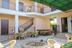 a patio with tables and chairs in a building at Hotel Kings Zatoka in Zatoka
