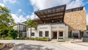 a large white building with a large roof at Wayam Mundo Imperial in Mérida