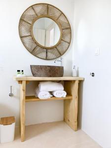 łazienka z umywalką i lustrem na półce w obiekcie Almyriki w mieście Mylopotas