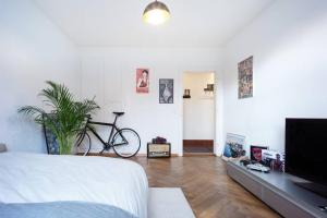 a bedroom with a bed and a bike on the wall at -TheUrbanist- in Bern