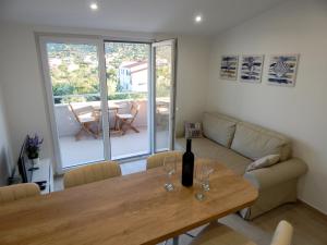 a living room with a table with wine glasses on it at Sweet Escape Apartments in Vinišće