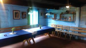 a dining room with a blue table and chairs at Organistowka in Bircza +16 photos