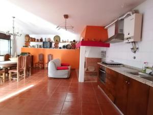 a kitchen with a table and a dining room at Gerês e Cabreira - Casa Alexandrina Vilar in Frades