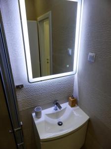 a bathroom with a sink and a large mirror at Sweet Escape Apartments in Vinišće +30 photos