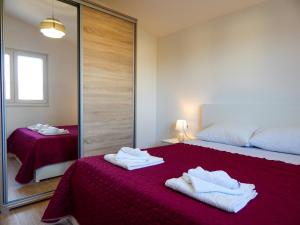 a bedroom with a bed and a mirror at Sweet Escape Apartments in Vinišće