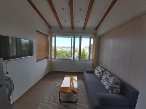 a living room with a blue couch and a table at Apartments Adria in Jadrija