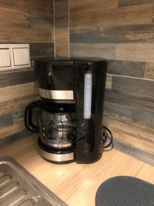 a coffee maker sitting on top of a counter at The green apartment in Kavála