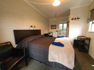 a bedroom with a large bed in a room at Matador Motel in Carterton