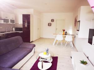 a living room with a couch and a table at Apartmani "Sandro" Gonar in Rab