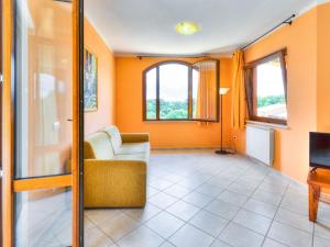 a living room with orange walls and a couch at Charming Holiday Home in Sorano with Swimming Pool in Sorano