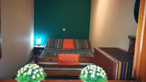 a bedroom with a bed and two potted plants at Garden Bungalow Valentina in Stavros