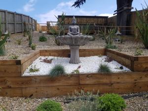 a garden with a fountain in the middle at Abbey Field - Cyanacottages in Whitby