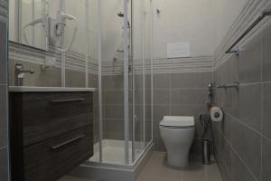 a bathroom with a glass shower and a toilet at Villa Giovanni in Palinuro +1 photo