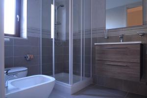 a bathroom with a shower and a toilet and a sink at Villa Giovanni in Palinuro