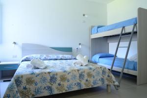 a bedroom with two bunk beds and a desk at Villa Giovanni in Palinuro