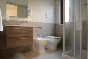 a bathroom with a toilet and a sink and a shower at Villa Giovanni in Palinuro