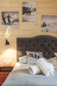 a bedroom with a bed and pictures on the wall at Rezydencja Zakopane in Zakopane