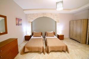 Postel nebo postele na pokoji v ubytování Villas metoxi