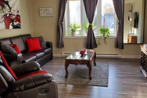 a living room with a couch and a coffee table at 2-Bedroom Apartment Sweet #2 by Amazing Property Rentals in Gatineau