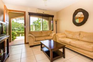 a living room with a couch and a table at Nicely priced well-decorated unit with pool near beach in Brasilito in Brasilito