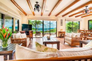 sala de estar con muebles y TV en Hacienda-Style Villa with Pool and Sweeping Ocean Views Above Potrero, en Potrero