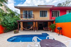 a villa with a swimming pool and a house at Nicely Priced Duplex in Surfside with Private Pool and AC in Every Room in Potrero