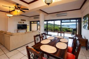 a dining room with a table and a couch at Big-beautiful unit in Flamingo sleeps 8-with breathtaking ocean views in Playa Flamingo