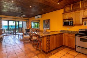 a kitchen with yellow walls and a table with chairs at Warm Interiors and Orange Hues on Ground Floor in Front of Beach in Playa Flamingo