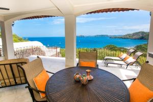 a table on a patio with a view of the ocean at Prestine ocean view 3BR condo in Playa Hermosa