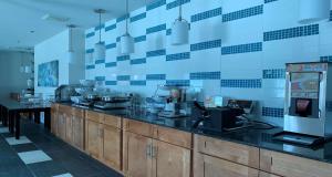 a kitchen with a counter top with aperature at SureStay Plus Hotel by Best Western Niagara Falls East in Niagara Falls