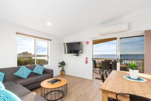 een woonkamer met een bank en een tafel bij Venus Bay Beachfront Tourist Park South Australia in Venus Bay