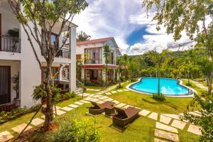 an image of a villa with a swimming pool at Caesar Phu Quoc Hotel in Phú Quốc