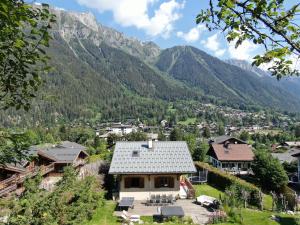a house with a view of a mountain at Chamonix Large Chalet, Sleeps 12, 200m2, 5 Bedroom, 4 Bathroom, Garden, Jacuzzi, Sauna in Chamonix-Mont-Blanc