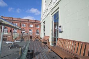 a balcony with a bench on the side of a building at Hotel Waterloo & Backpackers in Wellington
