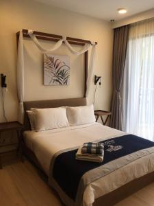 a bedroom with a bed and a window with curtains at kuantan staycationtimurbay in Kuantan