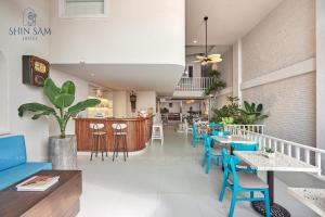 a restaurant with tables and chairs and a bar at Shin Sam Boutique Hotel in Vung Tau