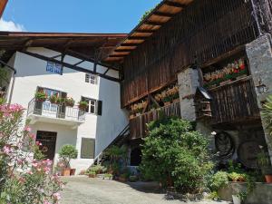 a building with flower boxes on the side of it at Glögglhof in Lana