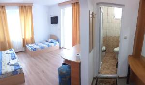 a small room with a bedroom and a bathroom at Primorsko Apartments in Primorsko