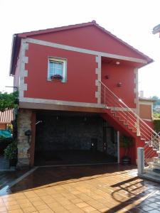 a red house with a staircase on it at Eira Vella in Mos