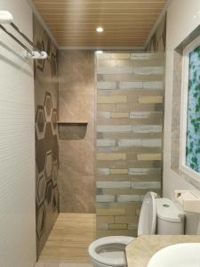 a bathroom with a toilet and a sink at My Home Aceh in Banda Aceh