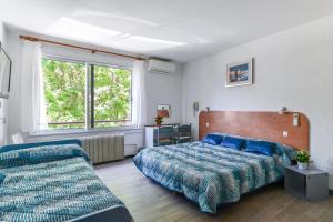 サント・マキシムにあるLe Preconilのベッドルーム1室(ベッド1台、ソファ、窓付)