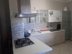 a kitchen with a stove and a white counter top at Casa vacanza salento GiovAsia in Sannicola